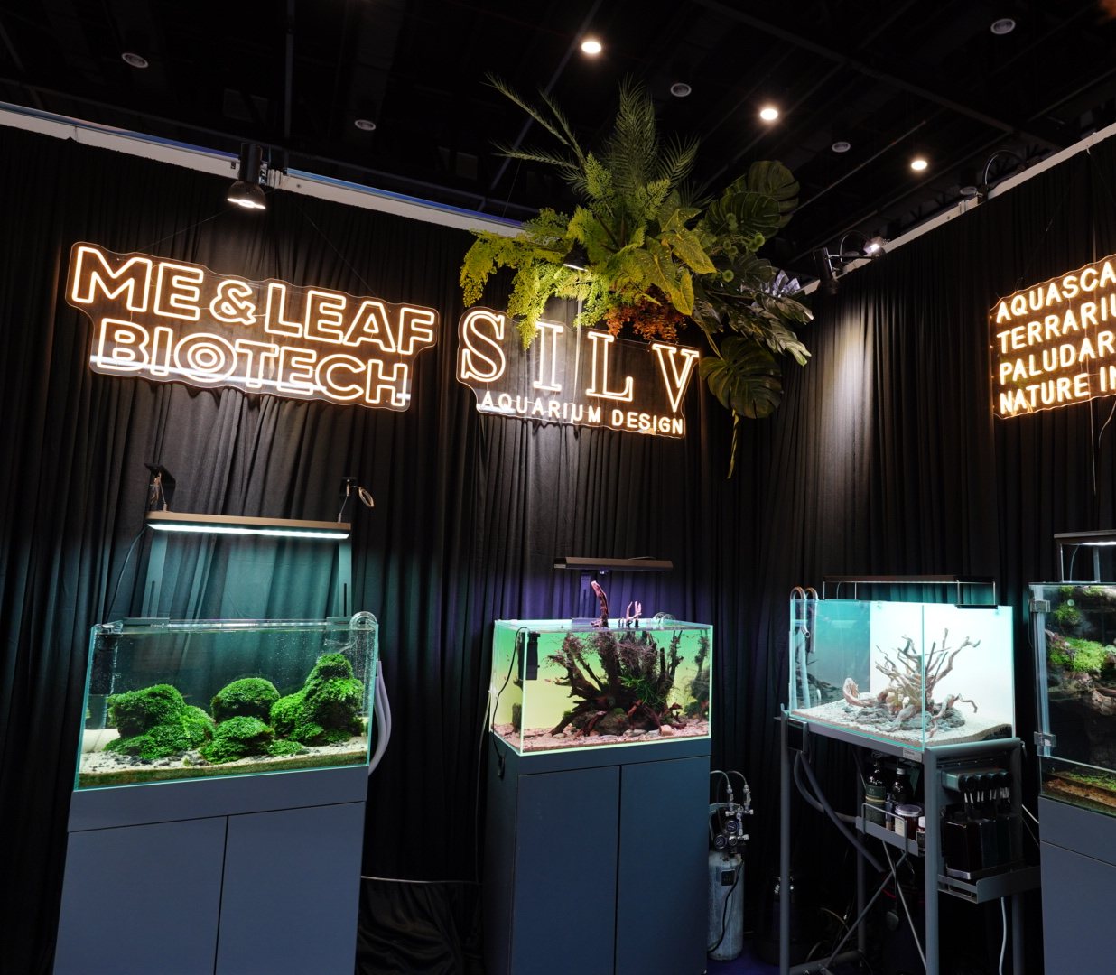 SILV expo booth with neon signage and planted display tanks